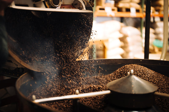 Coffee pouring from a roaster into a cooling tray