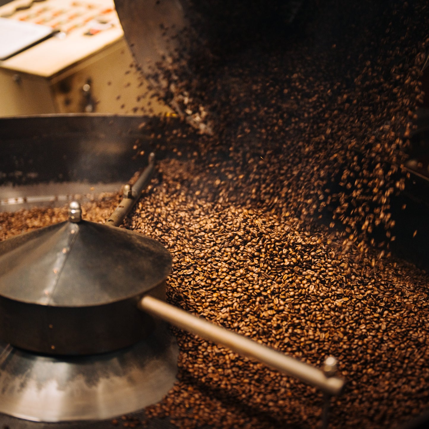 Coffee being released from Roaster at our Bellingham roasting facility