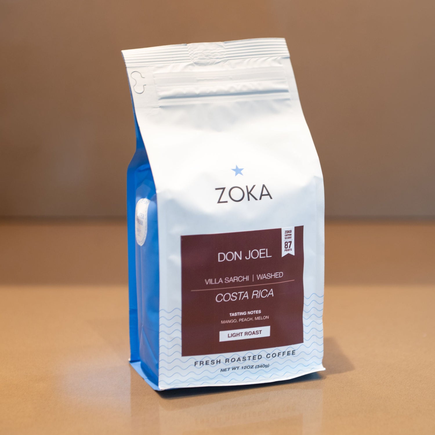 Zoka coffee bag on a wooden surface with a neutral background