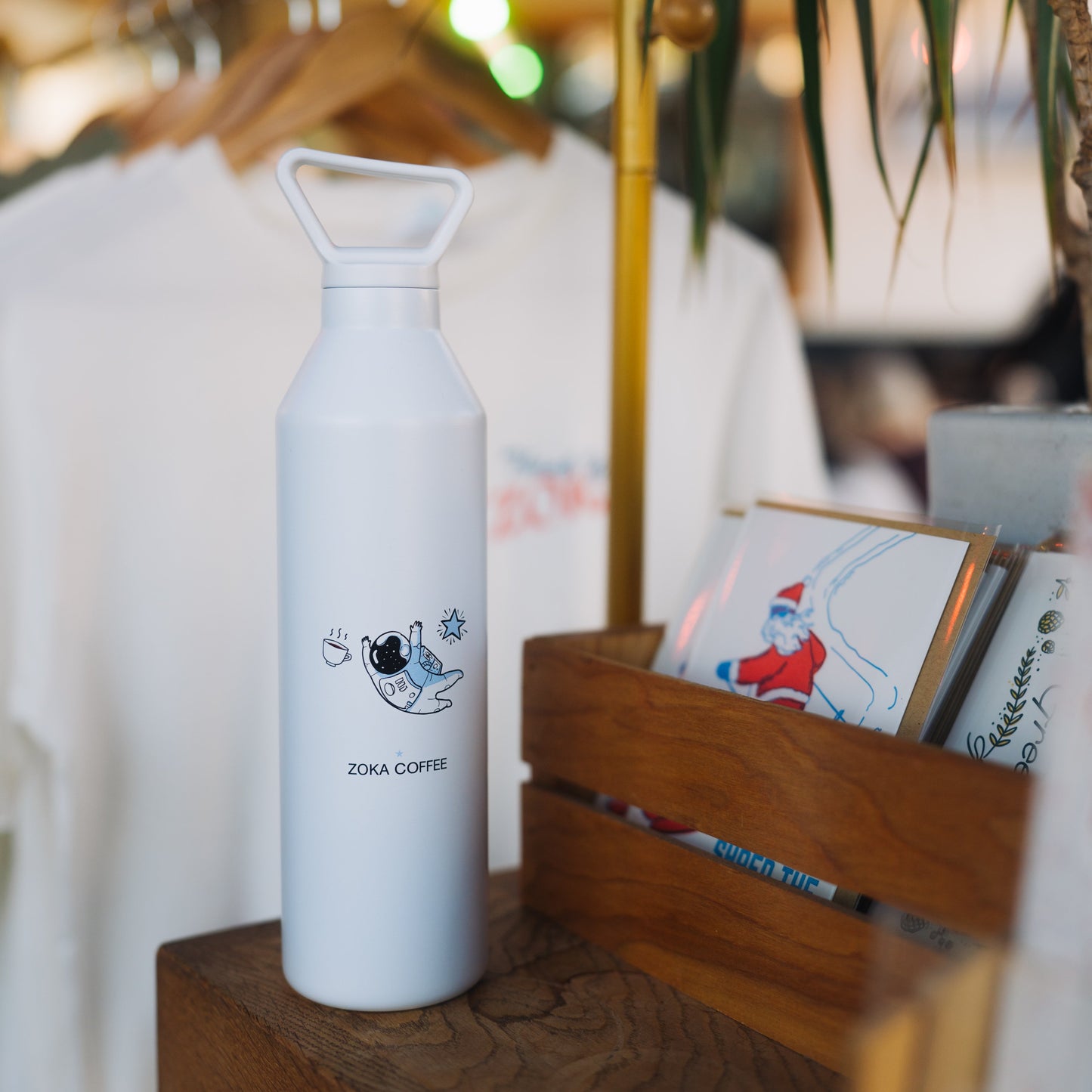 white tall skinny MiiWater Bottle with astronaut  design and zoka logo