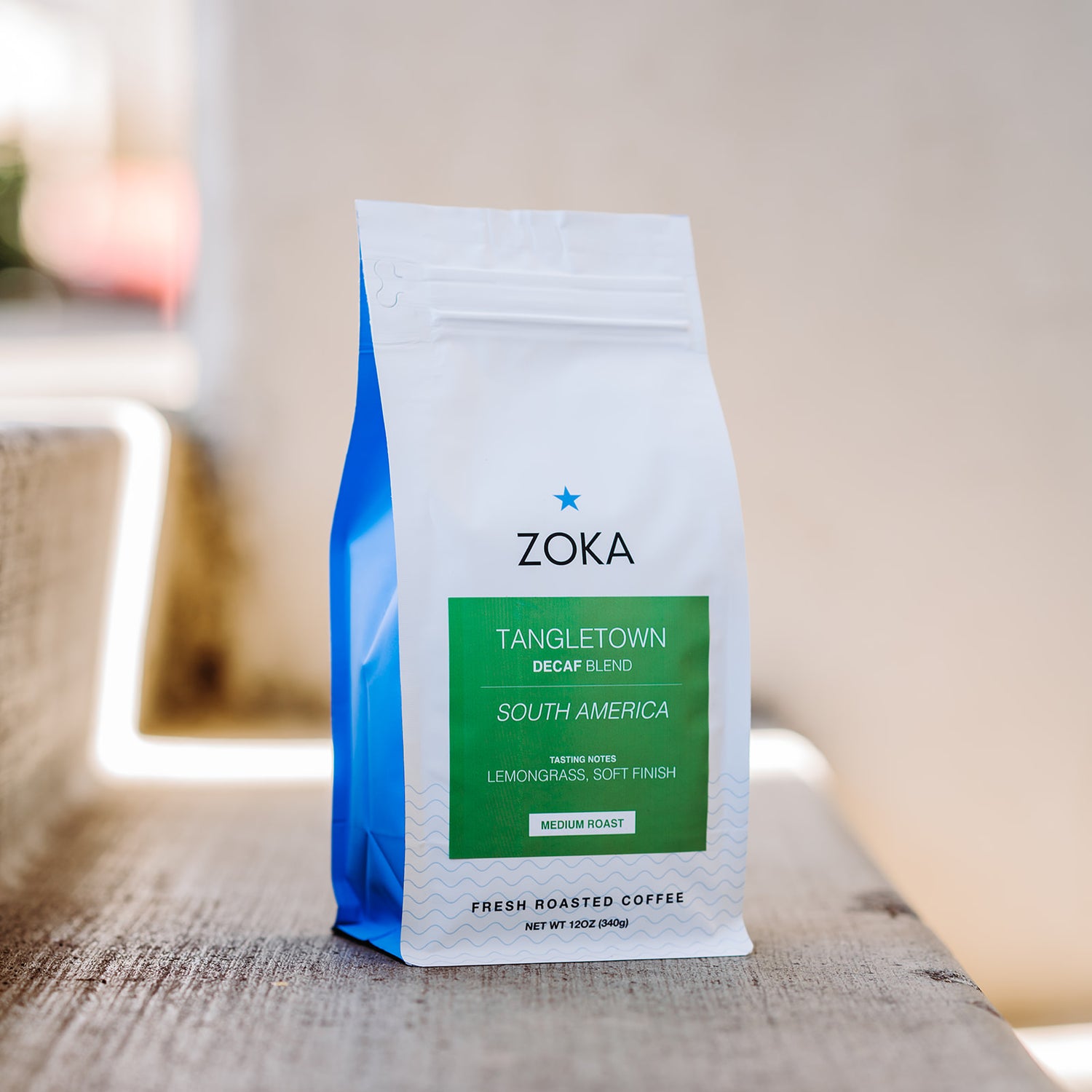 Zoka coffee bag on a wooden surface with a blurred background
