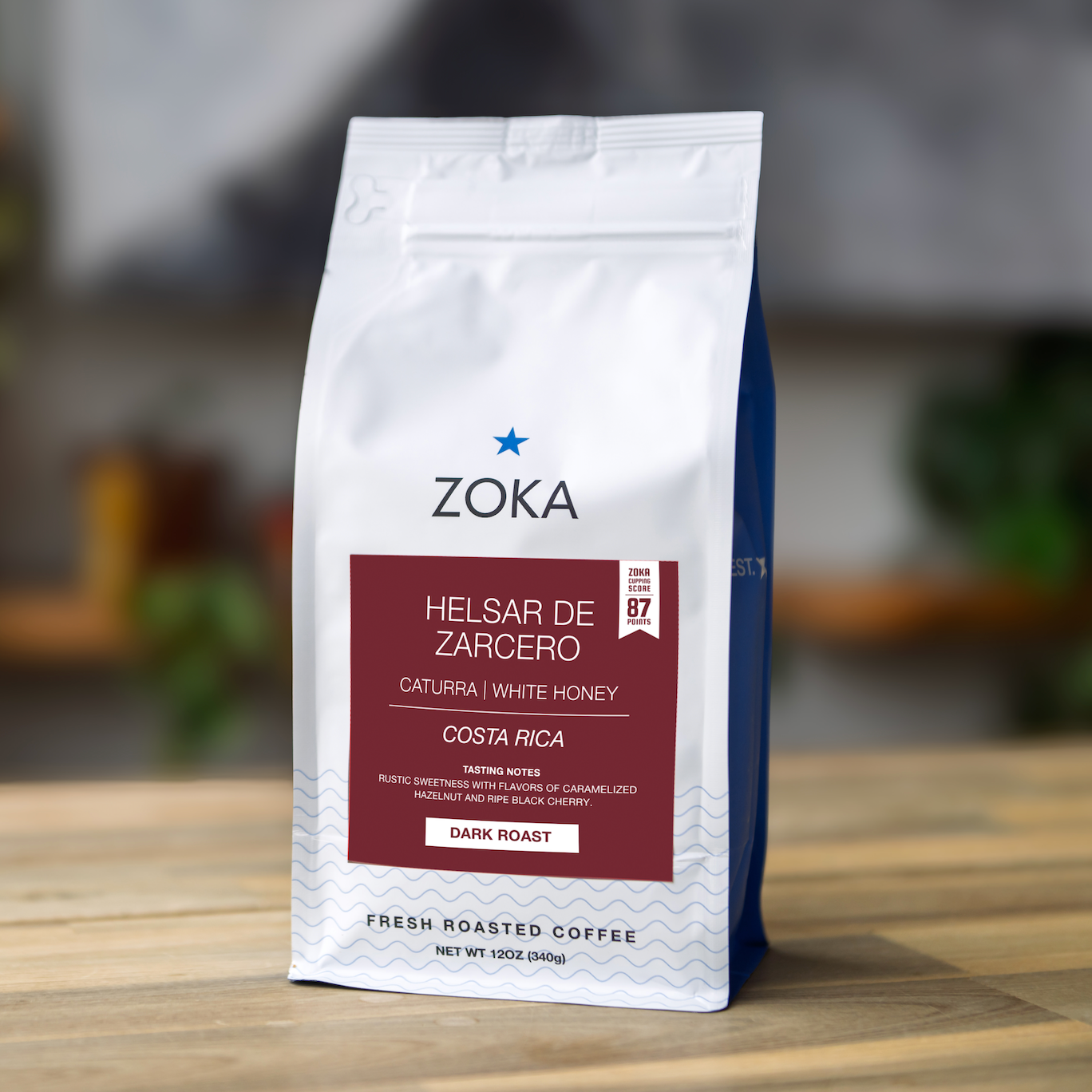 Zoka coffee bag on a wooden surface with a blurred background