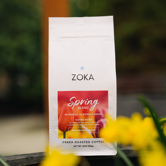 Zoka Spring Blend coffee package with yellow flowers in the foreground