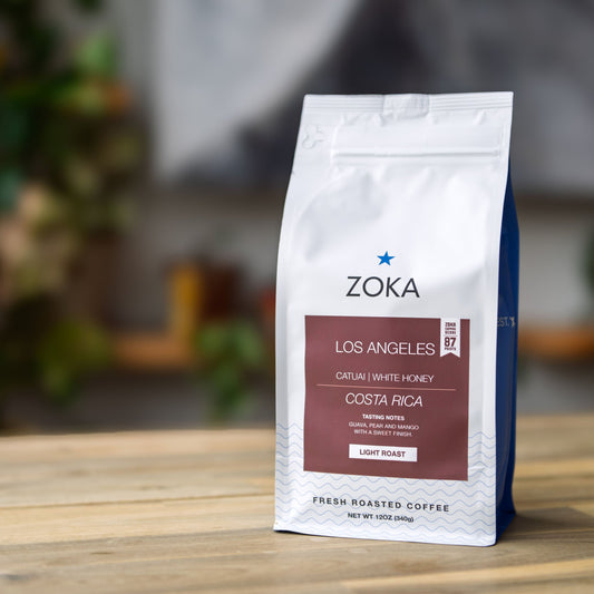 Zoka coffee bag on a wooden surface with a blurred background